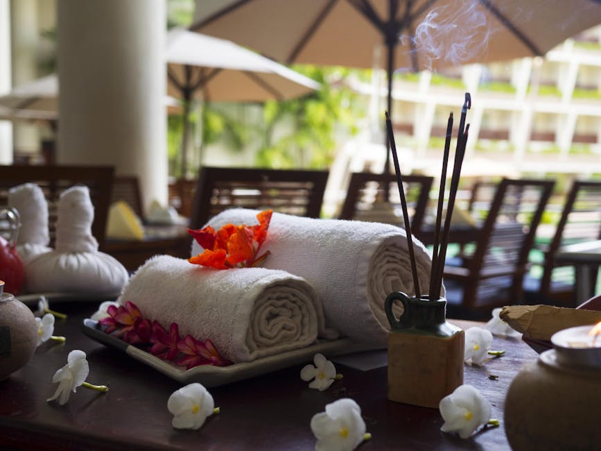 Relaxing spa scene with towels, incense, and flowers, perfect for wellness themes.