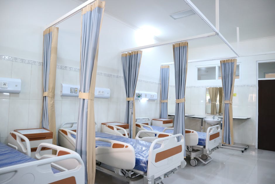 Spacious hospital ward with modern equipment and private patient areas
