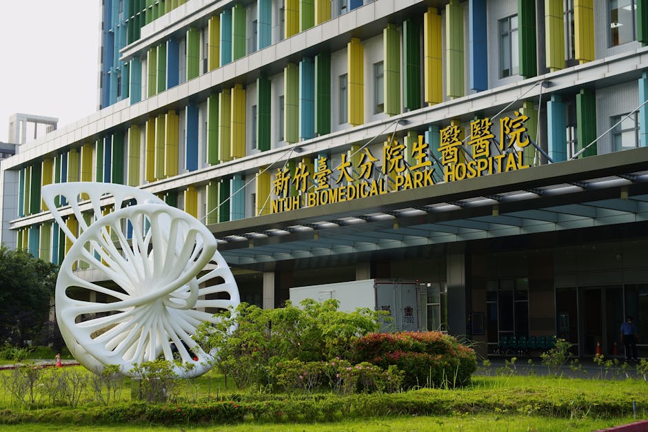 Entrance to NTUH Biomedical Park Hospital with modern sculpture and colorful facade in Taiwan